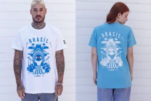 Um casal utilizando as peças que apresentam estampas que valorizam a brasilidade e refletem a diversidade cultural do país, reforçando o compromisso da iniciativa com a produção local e a geração de impacto social positivo.