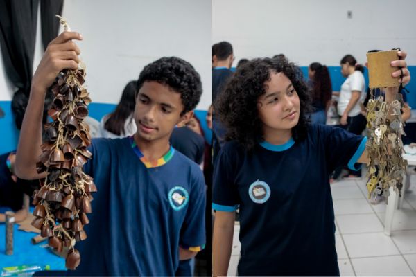 Um menino e uma menina segurando um instrumento de percussão